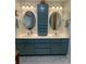 Bright bathroom with blue cabinets, dual sinks, and modern fixtures at 103 Boyd Dr, Stanley, NC 28164