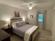 Cozy bedroom featuring a queen bed, soft lighting, and a large window at 103 Boyd Dr, Stanley, NC 28164