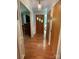 Inviting hallway with hardwood floors, wooden front door, and neutral paint creates a warm welcome at 103 Boyd Dr, Stanley, NC 28164