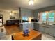 Modern kitchen with neutral cabinets, wood floors, and stainless steel appliances open to living room at 103 Boyd Dr, Stanley, NC 28164