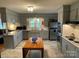 Updated kitchen with stainless steel appliances, and gray cabinets open to the living room at 103 Boyd Dr, Stanley, NC 28164