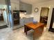 Bright kitchen with stainless steel double oven, neutral gray cabinets, and an adjacent dining area at 103 Boyd Dr, Stanley, NC 28164