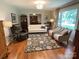 Comfortable living room with large window, hardwood floors, and a stylish area rug at 103 Boyd Dr, Stanley, NC 28164