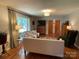 Bright living room featuring hardwood floors, neutral colors, and natural light from a large window at 103 Boyd Dr, Stanley, NC 28164