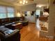 Spacious living room with hardwood floors, a comfortable seating area, and access to the kitchen at 103 Boyd Dr, Stanley, NC 28164