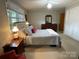 Bright main bedroom boasting a queen bed, large window, and classic wooden furniture at 103 Boyd Dr, Stanley, NC 28164