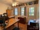 Functional home office with multiple workstations, built-in bookshelves, and a private entrance at 103 Boyd Dr, Stanley, NC 28164