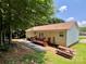 Backyard featuring a deck, brick patio, picnic table and gravel bed underneath a shady tree at 1031 Daniel Dr, Stanley, NC 28164