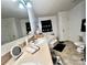 Bathroom featuring a vanity with a mirror, toilet, corner tub with black towel accents, and tile flooring at 1031 Daniel Dr, Stanley, NC 28164