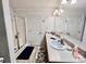 Bathroom with double sinks, shower, and large mirror, providing a bright and functional space at 1031 Daniel Dr, Stanley, NC 28164