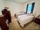 Bright bedroom featuring twin beds, natural light, and carpeted floor at 1031 Daniel Dr, Stanley, NC 28164