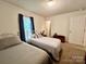 Bright bedroom with two twin beds, window, and overhead lighting at 1031 Daniel Dr, Stanley, NC 28164