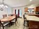 Bright eat-in kitchen with wood cabinets, an island with bar seating, and plenty of natural light at 1031 Daniel Dr, Stanley, NC 28164