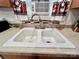 Close-up of a kitchen sink with a chrome faucet and an air conditioner in the background at 1031 Daniel Dr, Stanley, NC 28164