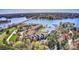 An aerial view showing lakefront condominiums with a tranquil fountain and docks, nestled in a lush, green landscape at 1038 Southwest Dr, Davidson, NC 28036