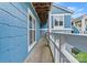 Private wooden balcony with blue siding and white railing overlooking lush greenery at 1038 Southwest Dr, Davidson, NC 28036