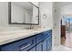 Bathroom vanity with marble countertop, blue cabinets, and brushed silver hardware at 1038 Southwest Dr, Davidson, NC 28036