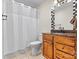 Traditional bathroom featuring a wooden vanity and a shower with a white curtain at 1038 Southwest Dr, Davidson, NC 28036