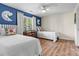 Cozy bedroom with twin beds, blue accent wall, and a window with natural light at 1038 Southwest Dr, Davidson, NC 28036