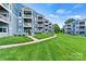 Beautiful blue condos with well-manicured lawn and sidewalk leading up to the buildings at 1038 Southwest Dr, Davidson, NC 28036