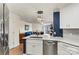 An open-concept kitchen boasts stainless appliances and island seating at 1038 Southwest Dr, Davidson, NC 28036
