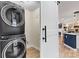 Modern laundry room featuring stacked washer and dryer, optimizing space and convenience at 1038 Southwest Dr, Davidson, NC 28036