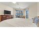 Cozy primary bedroom with dresser, TV, sliding glass doors to a balcony, and ample natural light at 1038 Southwest Dr, Davidson, NC 28036