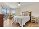 Well-lit primary bedroom featuring a bed, side tables, and sliding glass doors leading to a patio at 1038 Southwest Dr, Davidson, NC 28036