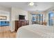 Primary bedroom boasts a bed, sliding glass doors to a patio, and dresser with TV at 1038 Southwest Dr, Davidson, NC 28036