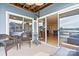 Relaxing covered patio area with nice furniture and glass sliding doors opening to living space at 1038 Southwest Dr, Davidson, NC 28036