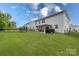 Spacious backyard featuring green grass, a trampoline, and a covered outdoor dining area at 1054 Thoroughbred Dr, Iron Station, NC 28080