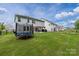 Large backyard features a trampoline, a covered patio with a dining set, and a well-maintained lawn at 1054 Thoroughbred Dr, Iron Station, NC 28080