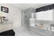 A bright bathroom with a freestanding soaking tub and glass shower at 1054 Thoroughbred Dr, Iron Station, NC 28080
