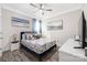 Bedroom features a ceiling fan, wood floors, and a blue and white patterned bedspread at 1054 Thoroughbred Dr, Iron Station, NC 28080