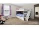 Charming bedroom features bunkbeds and cozy space with plush toys and natural light at 1054 Thoroughbred Dr, Iron Station, NC 28080