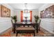 Formal dining room featuring an elegant light fixture, table setting, and wainscoting at 1054 Thoroughbred Dr, Iron Station, NC 28080