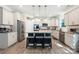 Modern kitchen with a spacious island, granite countertops, stainless steel appliances, and hardwood floors at 1054 Thoroughbred Dr, Iron Station, NC 28080