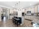 Open concept kitchen featuring an island with seating, stainless steel appliances, and lots of cabinets at 1054 Thoroughbred Dr, Iron Station, NC 28080