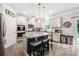 Bright kitchen featuring a center island with seating, stainless steel appliances, and ample cabinet space at 1054 Thoroughbred Dr, Iron Station, NC 28080