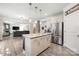 Spacious kitchen featuring an island with seating, stainless steel appliances, and an open view to the living room at 1054 Thoroughbred Dr, Iron Station, NC 28080