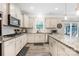 Modern kitchen with granite countertops, stainless steel appliances, and a sliding glass door at 1054 Thoroughbred Dr, Iron Station, NC 28080