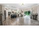 Open concept kitchen with stainless appliances, island, and access to patio at 1054 Thoroughbred Dr, Iron Station, NC 28080