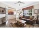 Inviting living room with a brown sofa, patterned rug, and lots of natural light at 1054 Thoroughbred Dr, Iron Station, NC 28080