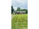 Charming brick ranch home featuring a covered side-entrance and spacious front yard at 1073 Springdale Dr, Maiden, NC 28650