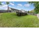 Green backyard with a wooden retaining wall, providing a serene and spacious outdoor space at 12829 Brandenburg Ln, Midland, NC 28107