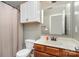 A bathroom with a wood vanity, white sink, and shower-tub combo at 12829 Brandenburg Ln, Midland, NC 28107