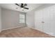 A carpeted bedroom with a ceiling fan, neutral walls, and closet at 12829 Brandenburg Ln, Midland, NC 28107