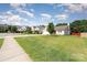 A well manicured front lawn and a view of similar homes in the neighborhood at 12829 Brandenburg Ln, Midland, NC 28107