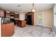 Eat in kitchen featuring dark cabinets, black appliances, and a functional island at 12829 Brandenburg Ln, Midland, NC 28107