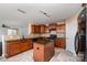 Spacious kitchen featuring an island, dark cabinetry, and modern appliances at 12829 Brandenburg Ln, Midland, NC 28107